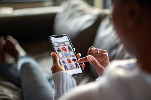 woman shopping for clothes online using her phone